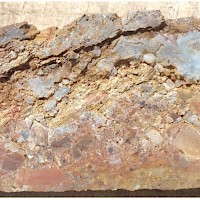 Figure 1. 20cm core at TDD-001 19m: Oxidised silicified ploy-mict hydrothermal breccia with stockwork banded veining.